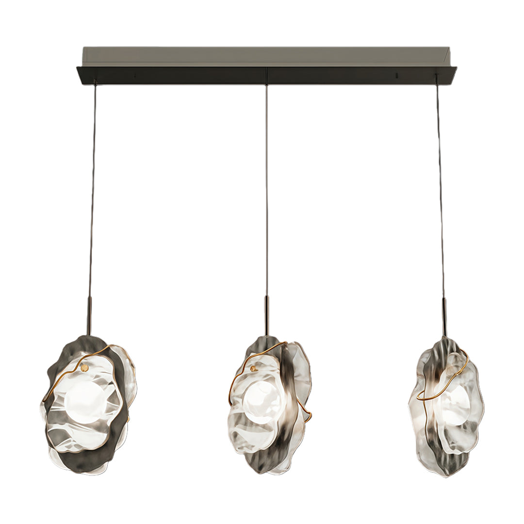 Three-light fun pendant light featuring linear canopy with evenly spaced textured glass fixtures