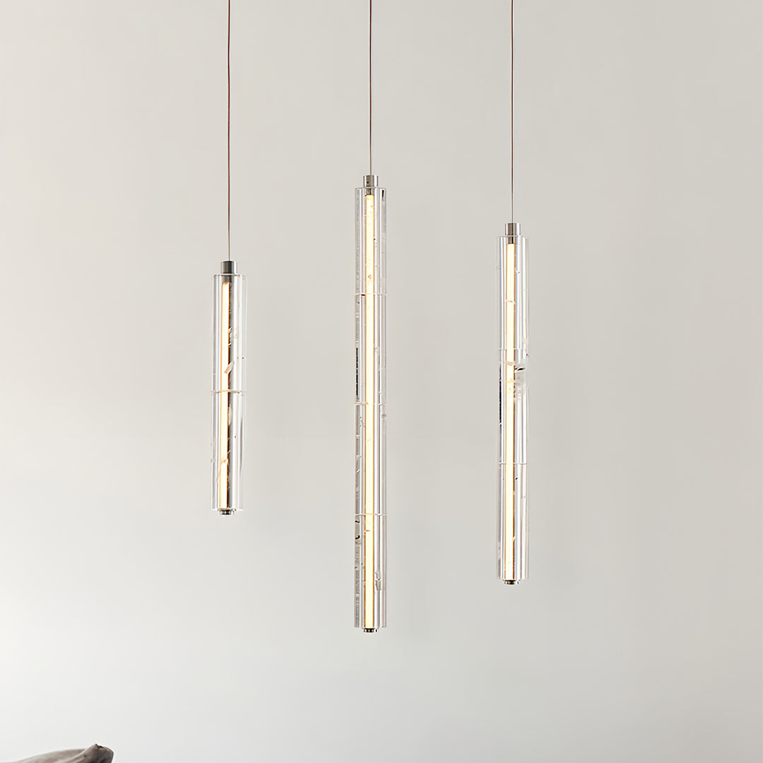 Three modern crystal pendant lights aligned vertically, creating a sophisticated look in a modern interior.