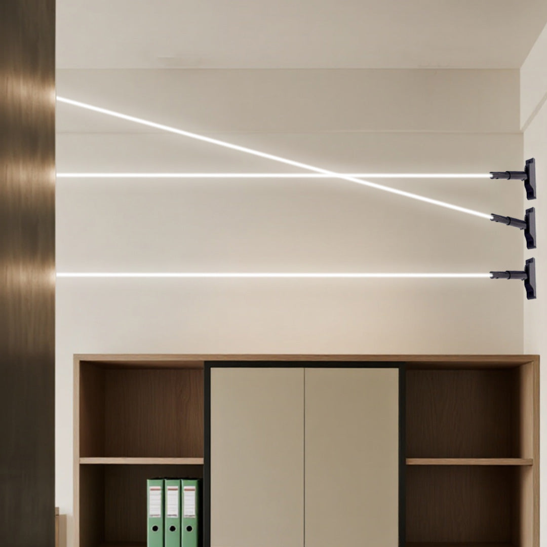 Three modern led lights strips for room glowing brightly across a wall above a wooden cabinet.
