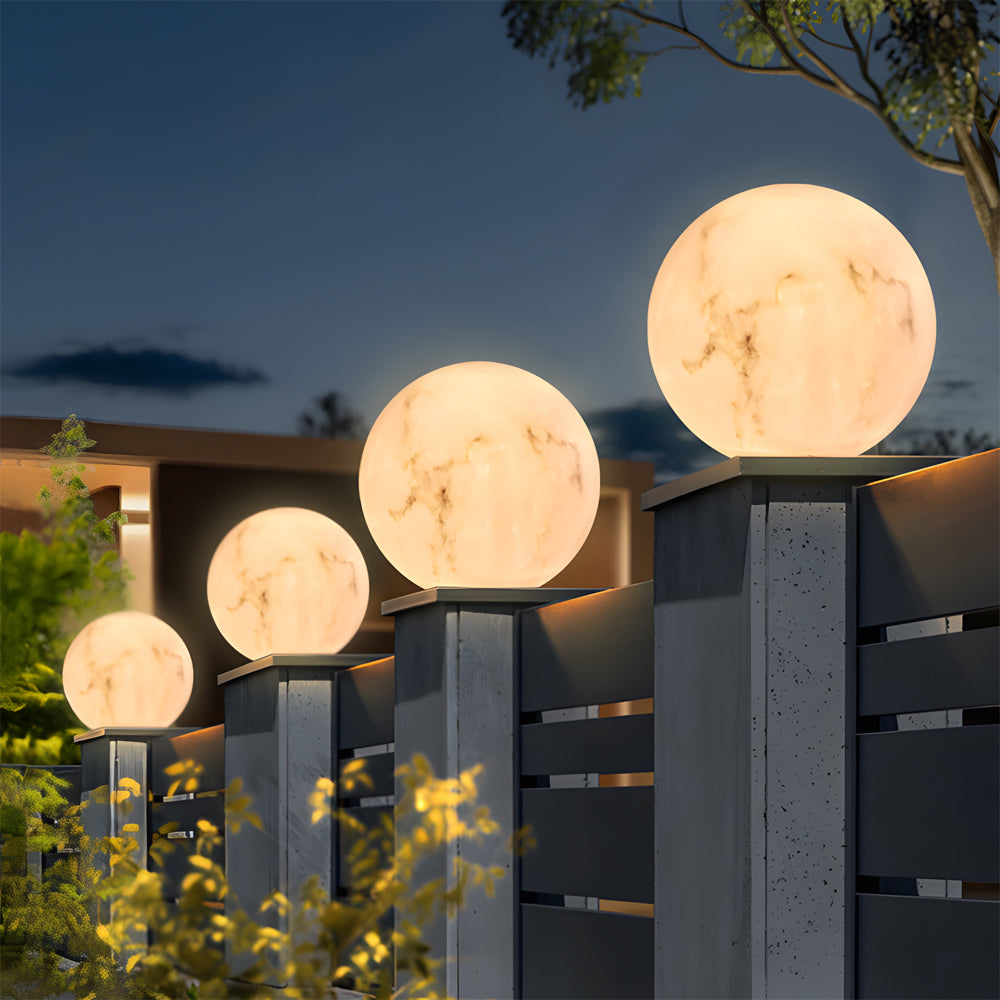 Three outdoor pillar lights mounted on a wooden fence, offering stylish and functional garden illumination.