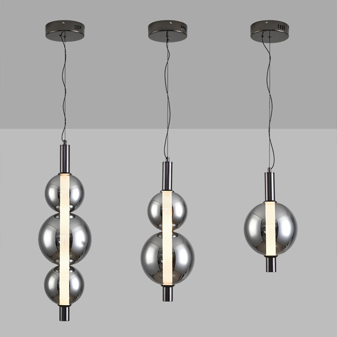 Modern pendant lights with metallic spherical shades, available in three designs: triple spheres, double spheres, and single sphere, mounted on round ceiling canopies.