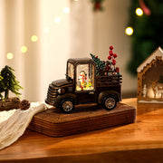 Three glowing decorative trucks arranged on a table, shining with modern gold table lamp–style warmth.