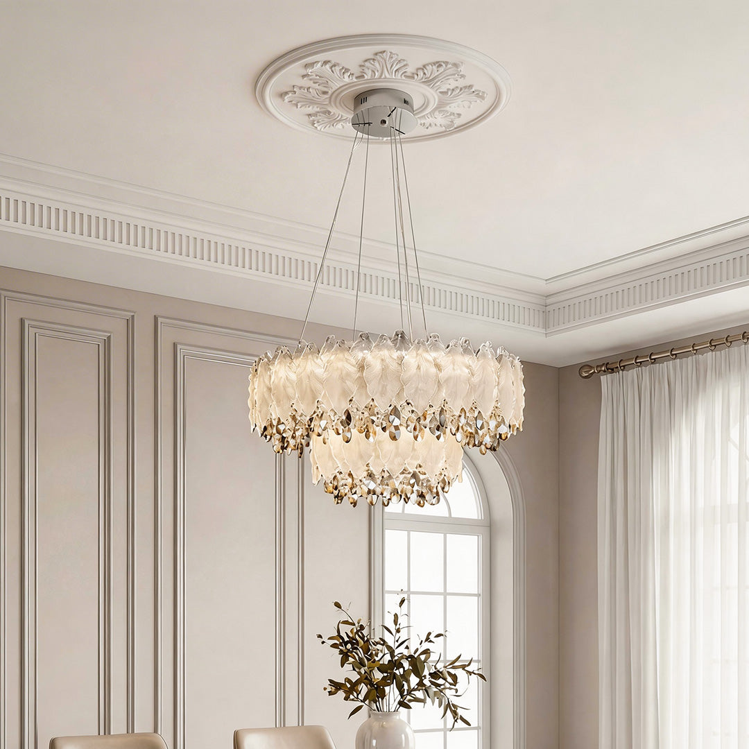 Stunning tiered country french chandelier featuring frosted glass petals and sparkling crystal accents suspended from an ornate ceiling medallion in an elegant room.