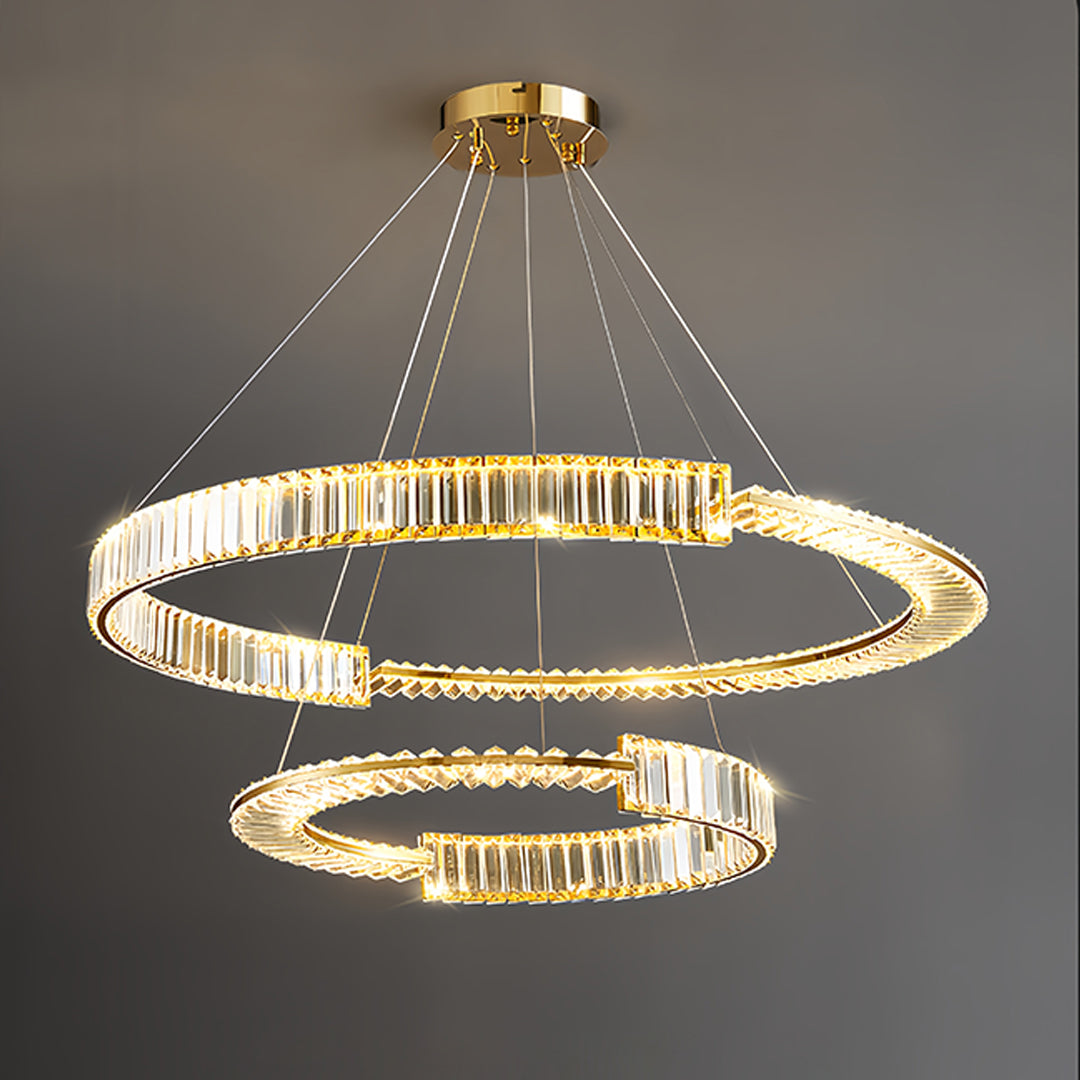 Gold crystal chandelier with tiered design installed in modern dining room setting