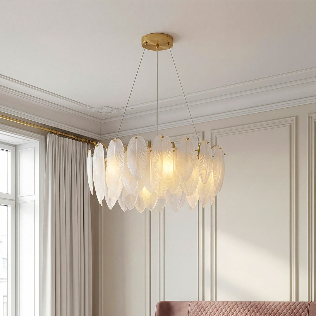 Elegant tiered feather chandeliers featuring a gold frame and frosted glass plumes in a sophisticated paneled room.