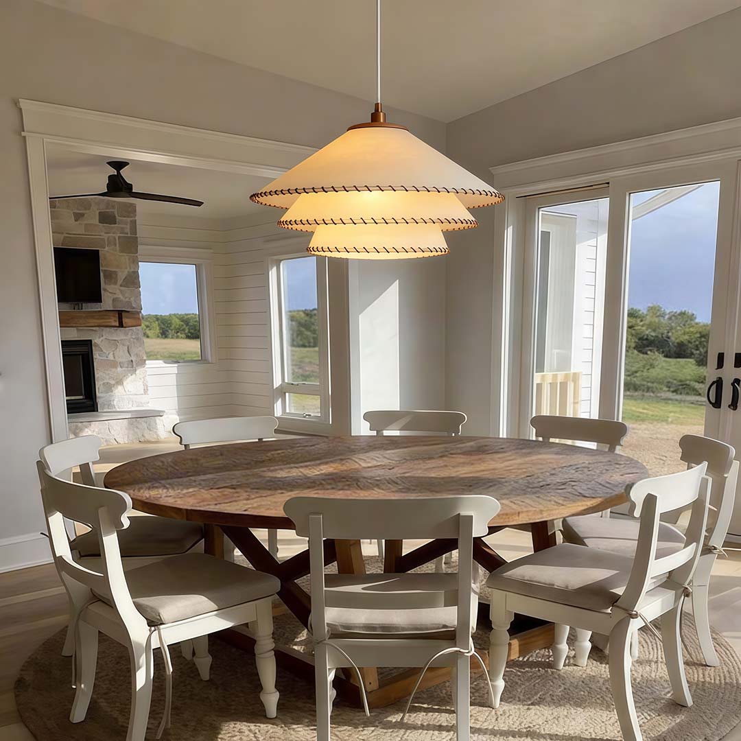 Tiered pendant light with a natural woven design, illuminating a rustic dining table.