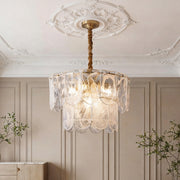 Luxurious tiered glass drum chandelier with scalloped panels and warm glowing LEDs, suspended.