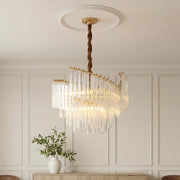 Elegant tiered vintage crystal chandeliers featuring a gold frame and cascading clear vertical crystal rods in a classic room with wainscoting.