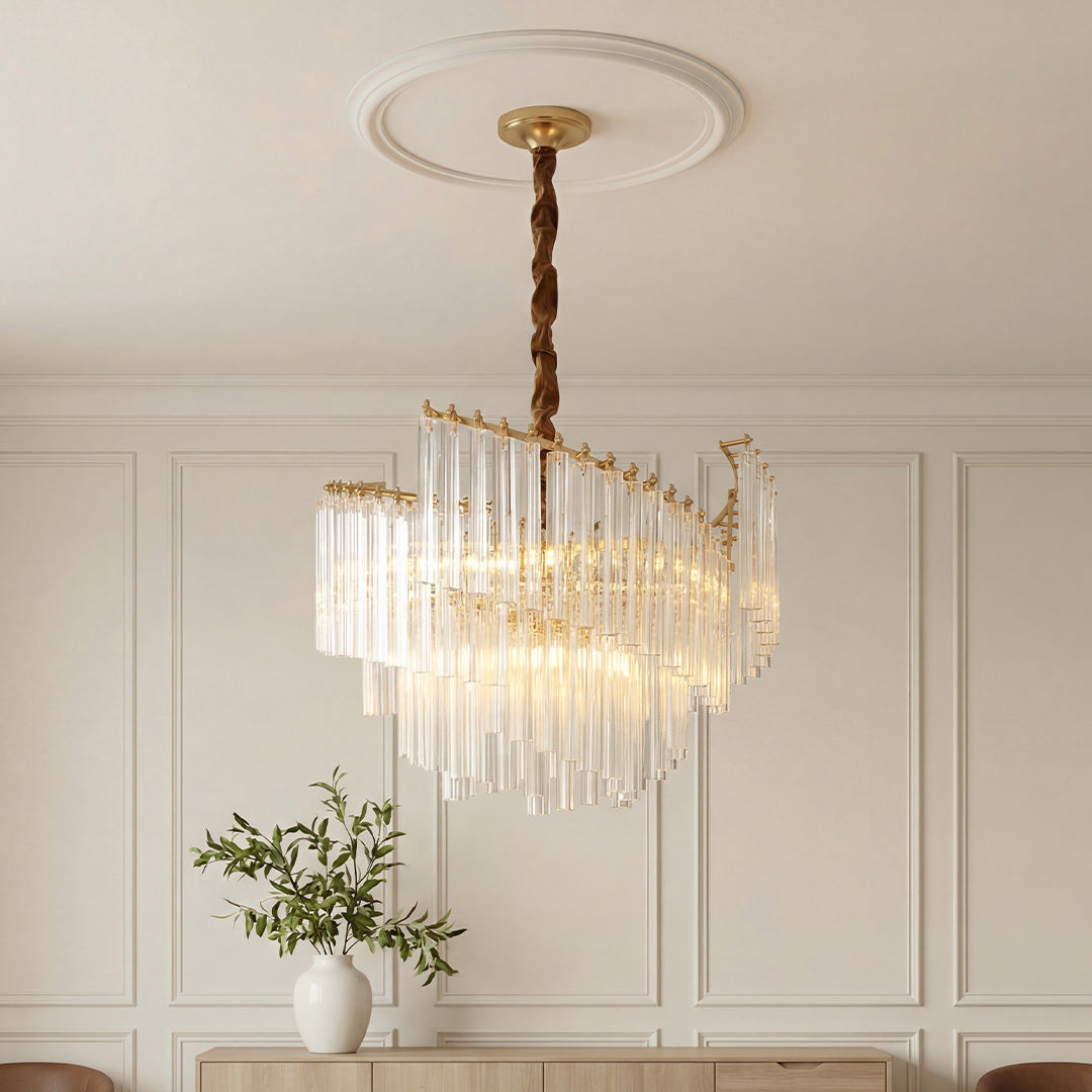Elegant tiered vintage crystal chandeliers featuring a gold frame and cascading clear vertical crystal rods in a classic room with wainscoting.