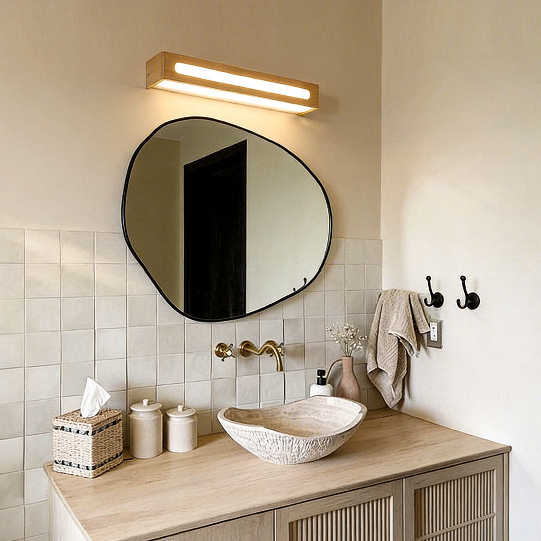 Warm glow from a timber vanity mirror light in a rustic bathroom design.