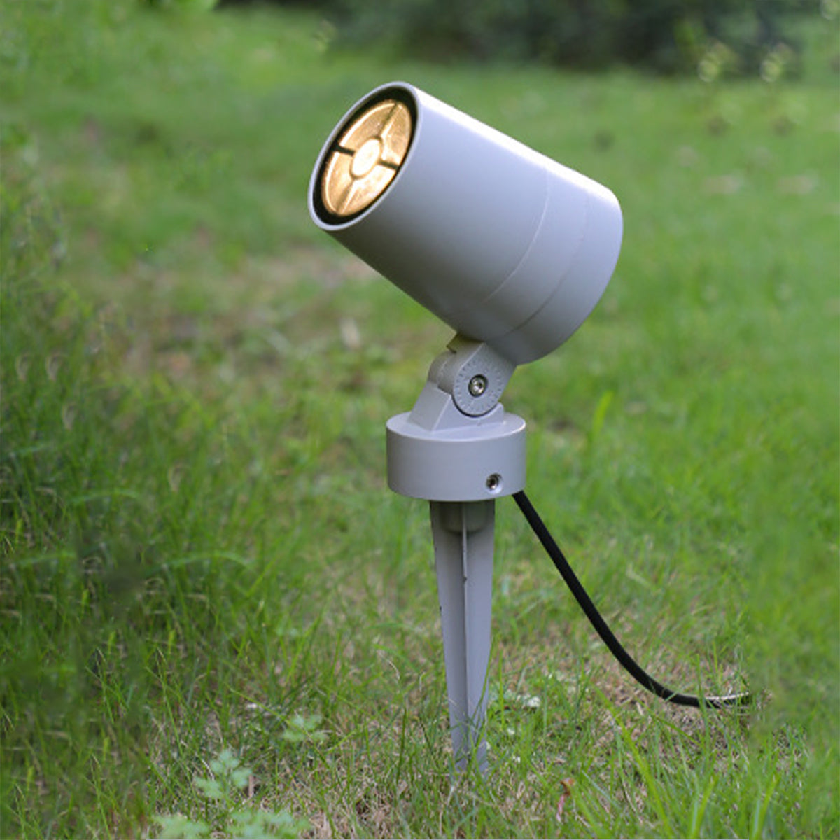 White outdoor spotlight with timer control dial and directional adjustment capabilities