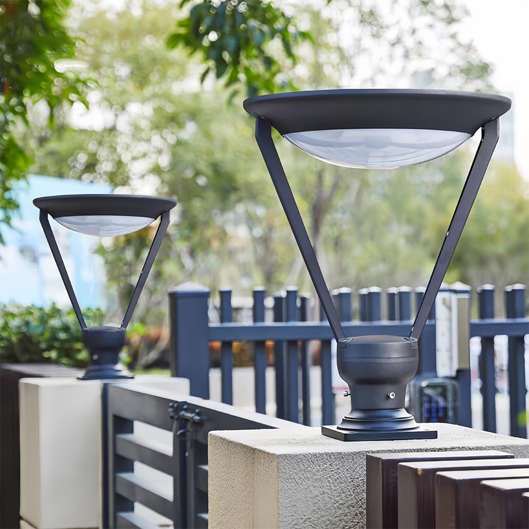 Top-down view of two modern solar-powered external pillar lights on a low stone and metal fence.