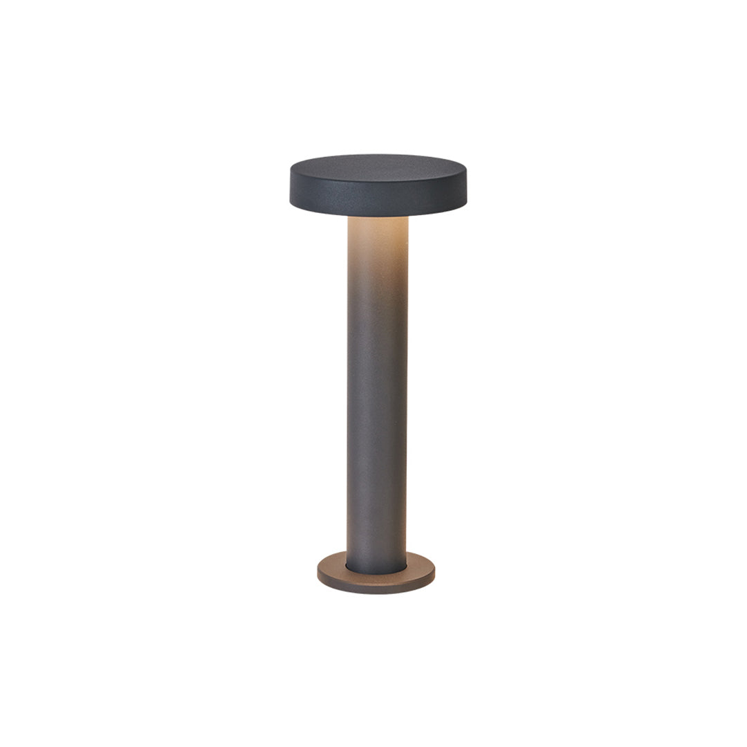 Modern black cylindrical LED path light with top illumination design for contemporary landscape lighting