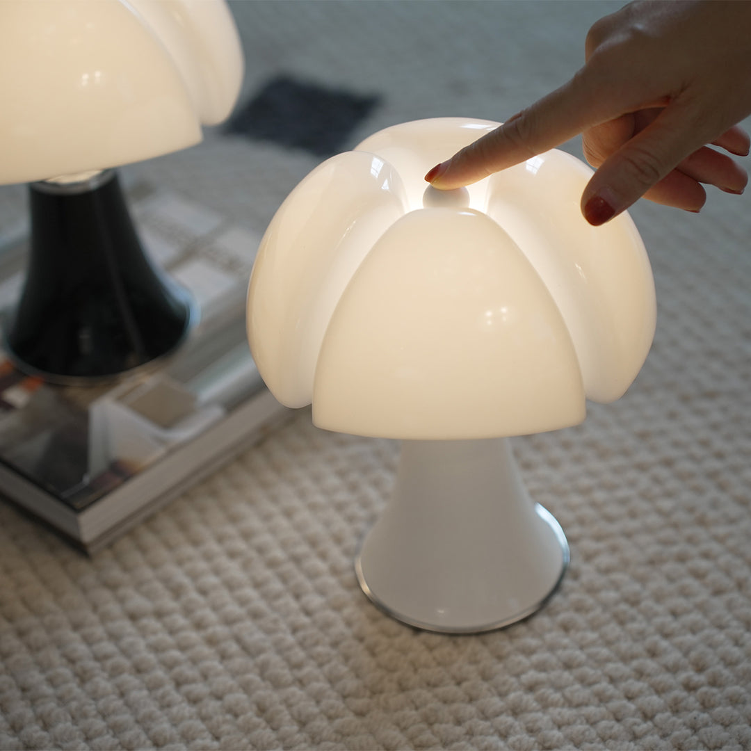 White mushroom-shaped Bauhaus lamp with touch control on bedside table.