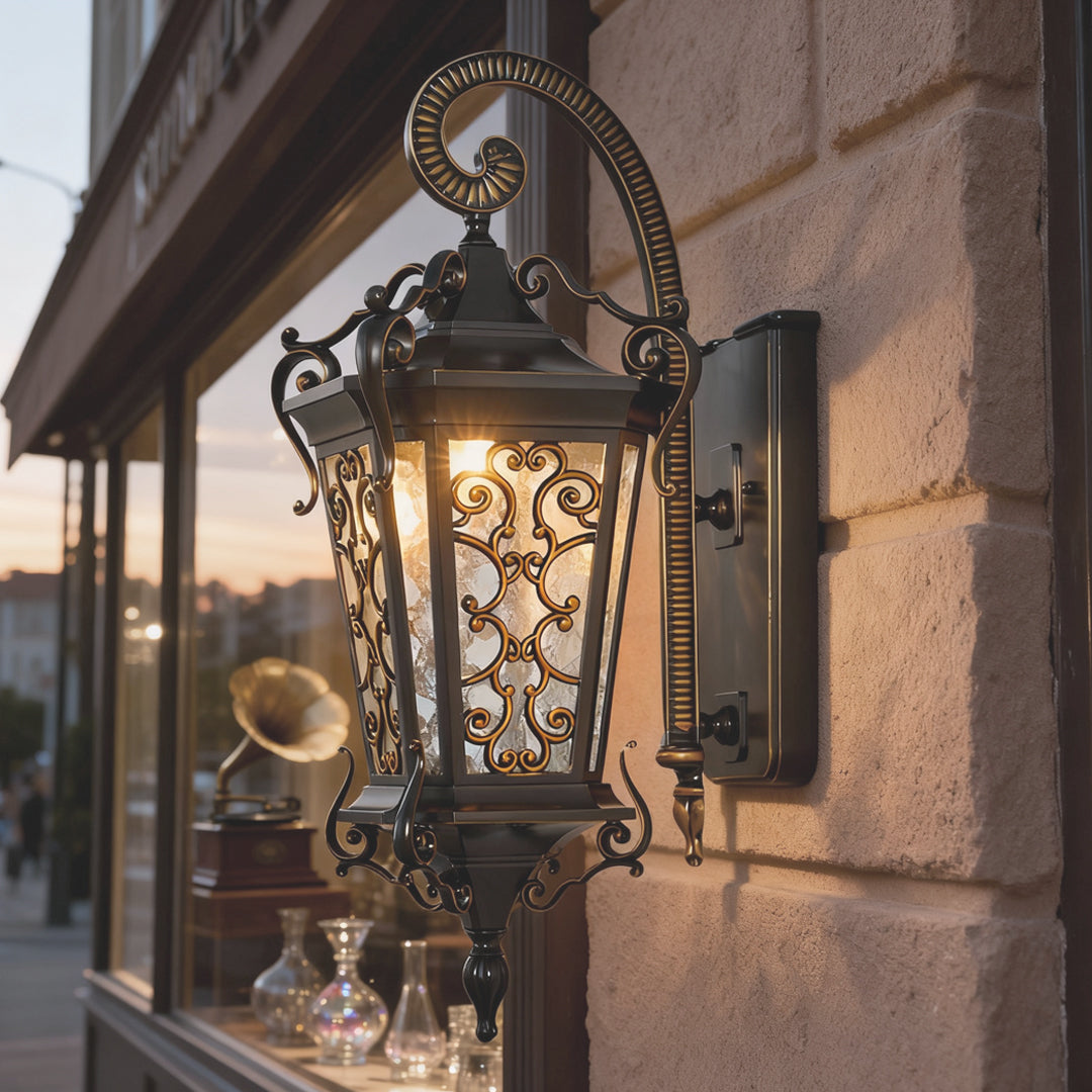 Traditional outdoor wall lantern with antique bronze finish mounted near window for exterior accent lighting.
