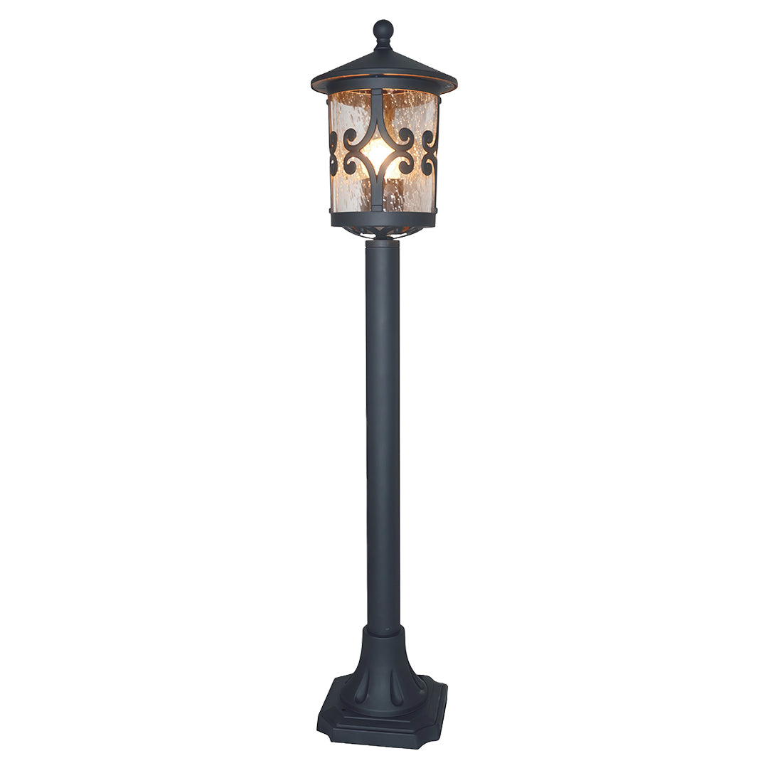 Traditional bollard LED light featuring ornate cutout design and amber glass on classic black pole