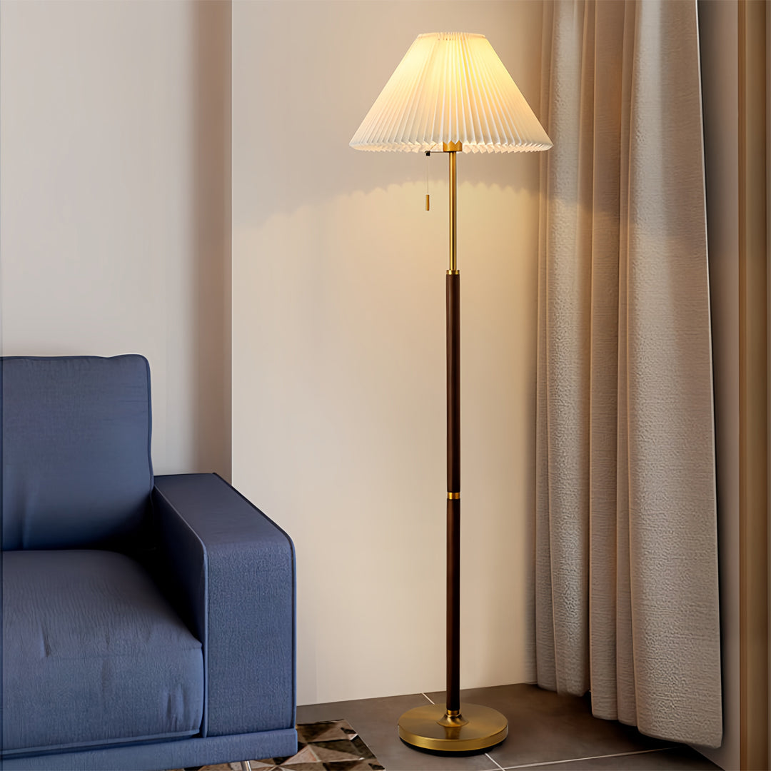 Traditional floor wood lamp beside modern blue chair creating perfect reading corner atmosphere