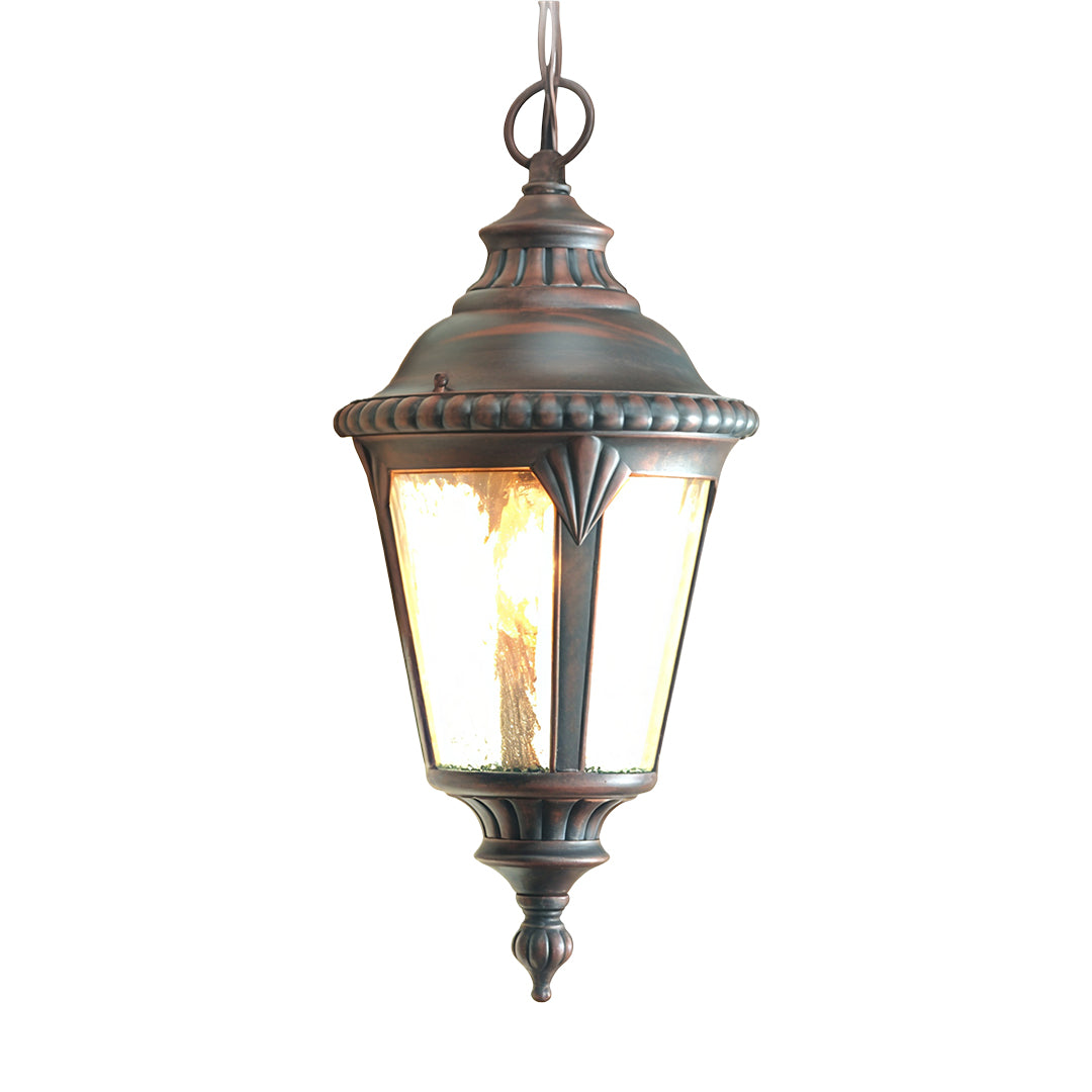 Traditional industrial pendant light featuring lantern design and warm amber glass on white background