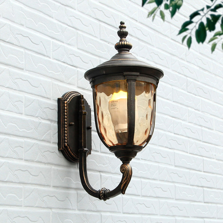 Traditional outdoor lantern illuminated on white exterior wall with natural shadows