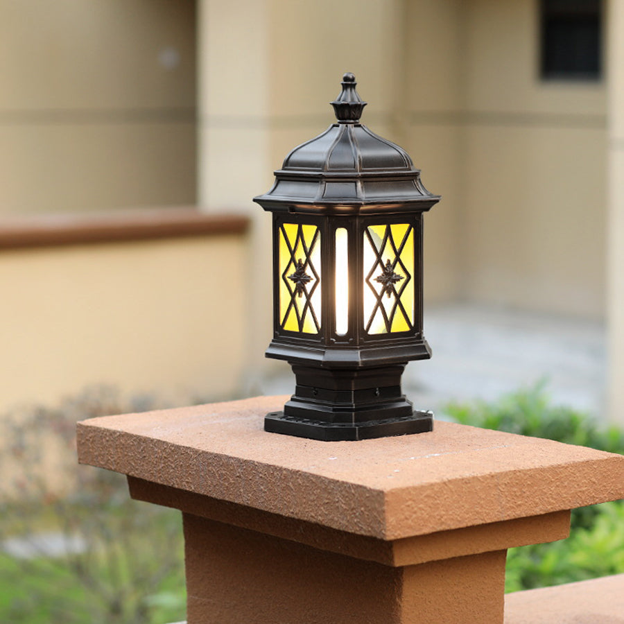 Traditional outside pillar lights featuring diamond pattern glass installed on wooden post caps for outdoor illumination