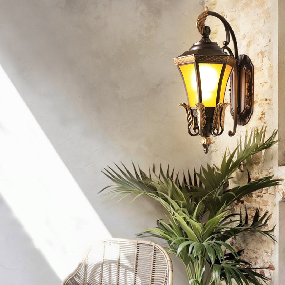 Traditional wall-mounted lantern with bronze finish and amber glass providing classic exterior lighting for residential entrance