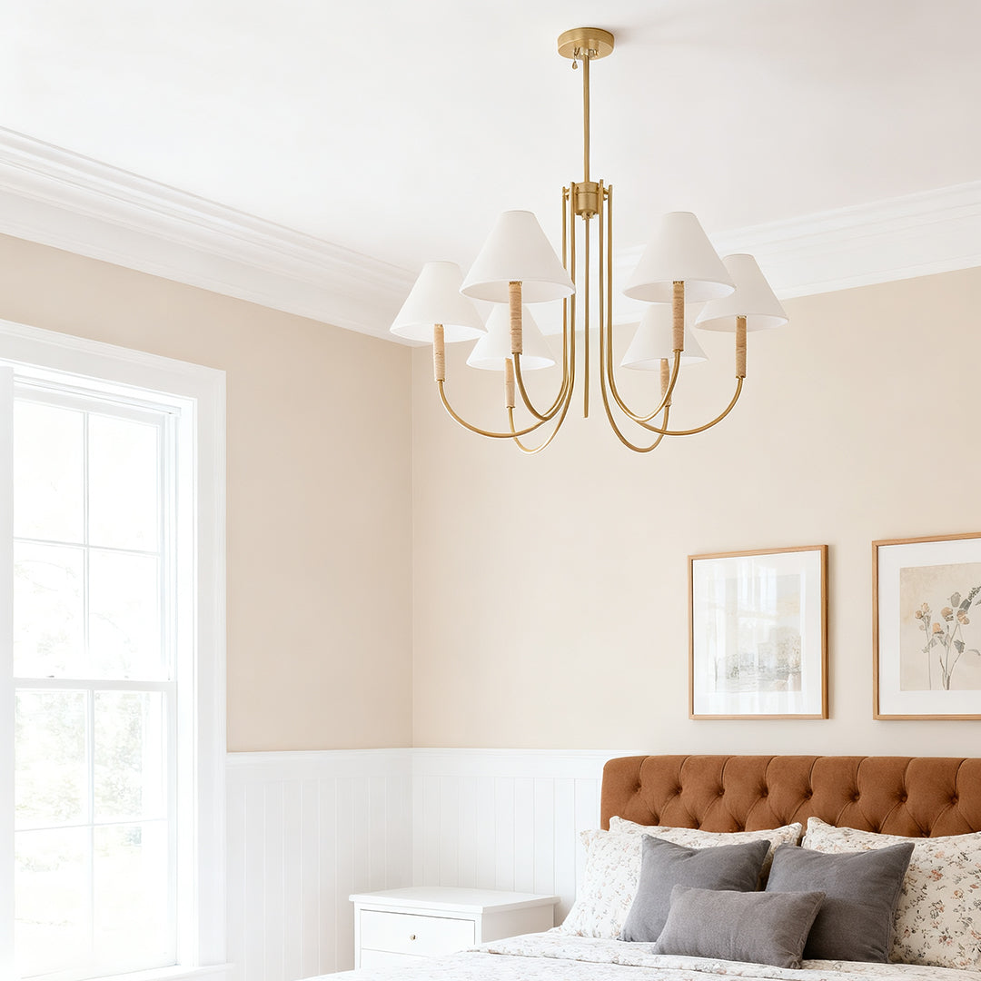 Transitional bedroom with a five-light cloth shade chandelier featuring gold hardware, providing soft illumination over the bed.