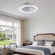 Transparent blade ceiling fan with light, installed in a modern bedroom with large windows.