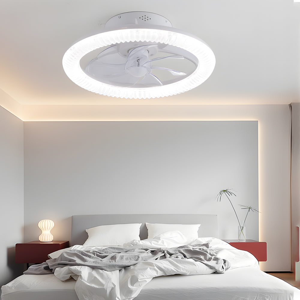 Transparent blade ceiling fan with light, mounted on a white ceiling in a stylish bedroom.