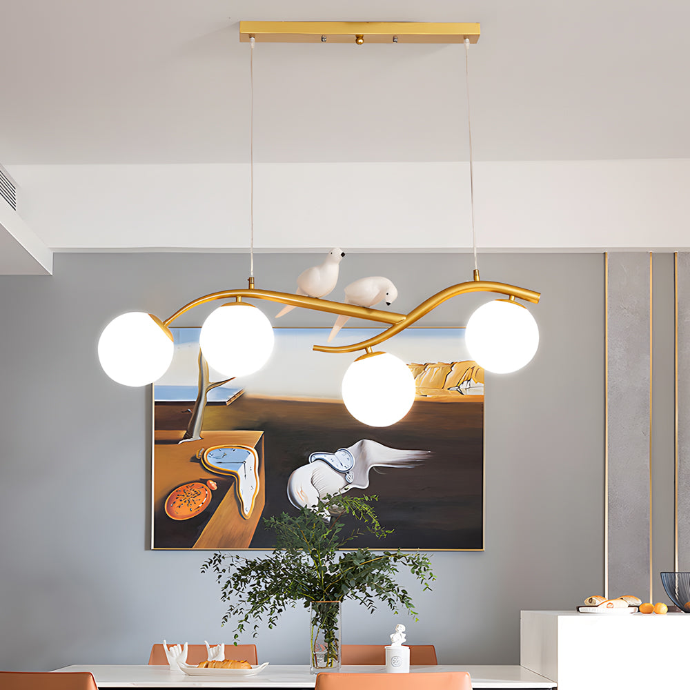 Tree branch pendant light with frosted and clear glass globes.