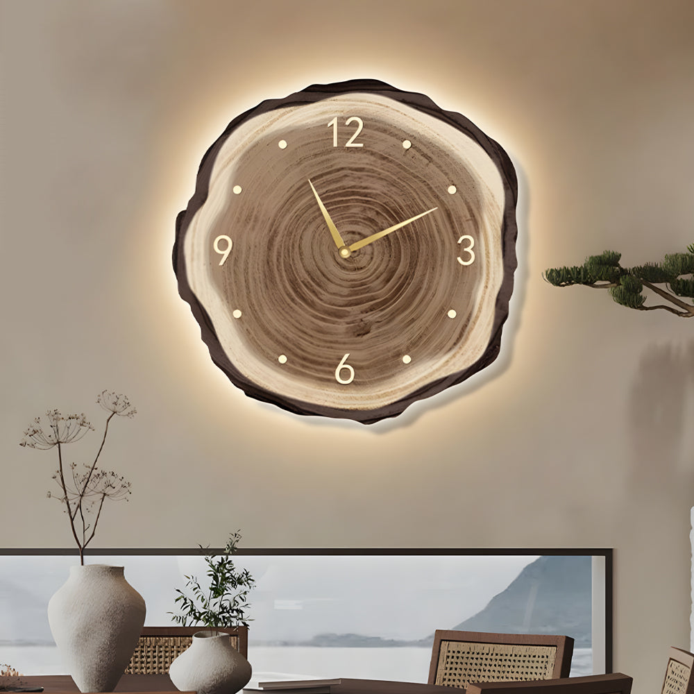 Backlit tree stump wall clock with soft illumination around the edges, highlighting the natural texture and modern style.
