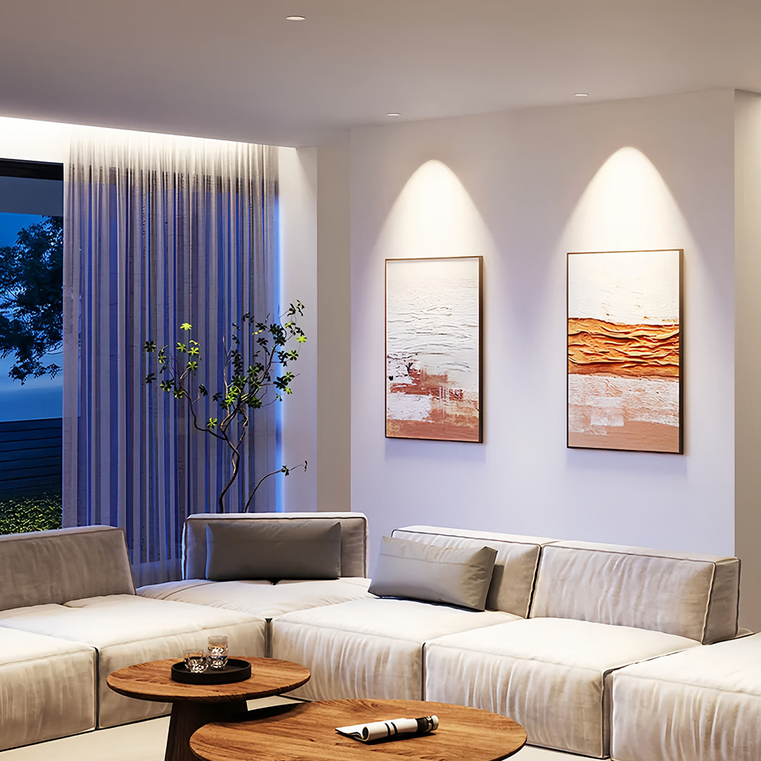 Trimless recessed downlights illuminating contemporary living room with white walls and arched alcoves