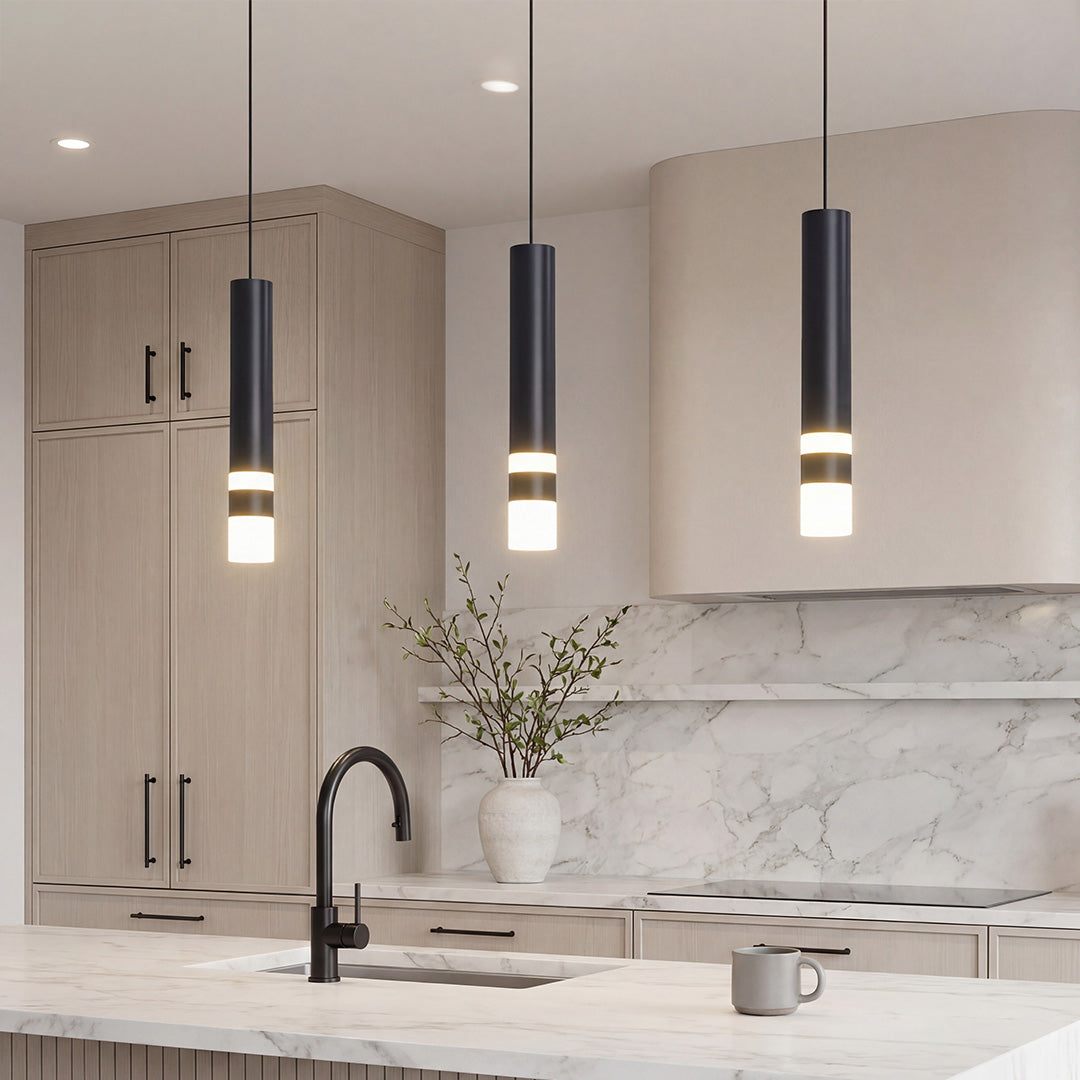 Trio of sleek Black LED Cylinder Pendant lights over a modern marble kitchen island setup.