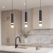 Trio of sleek Black LED Cylinder Pendant lights over a modern marble kitchen island setup.