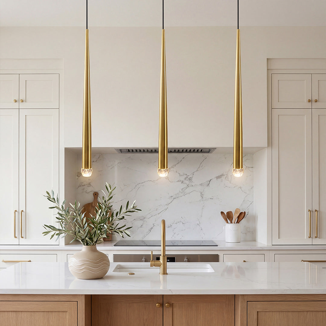 Trio of elegant Slim Gold Cone Pendant lights over a luxury marble kitchen island in bright home.