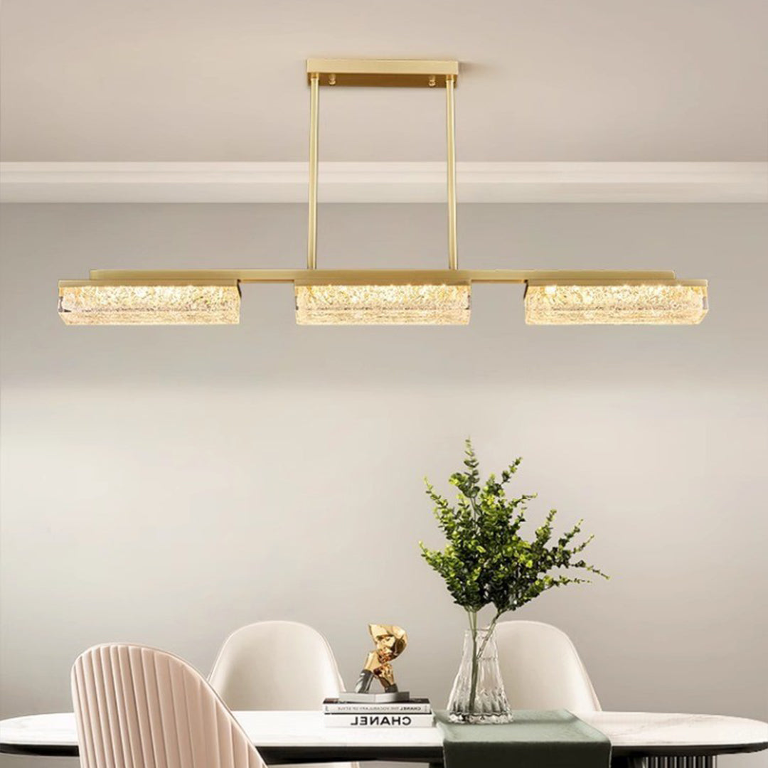 Triple copper pendant lights for kitchen island arrangement over white dining table