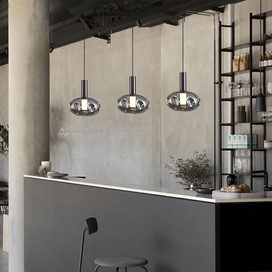 Triple drum pendant lights installation creating focal point in contemporary interior space