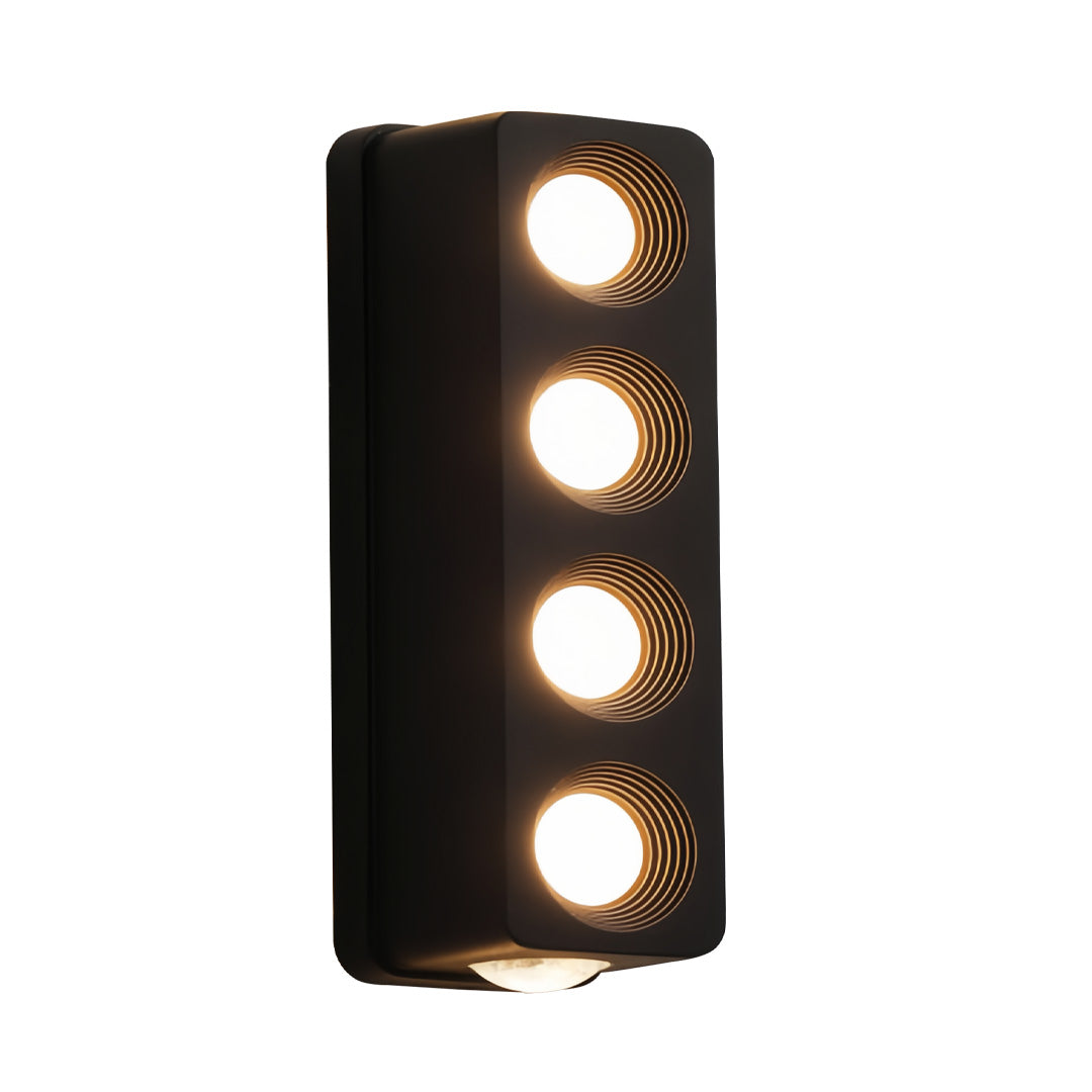 Three-light unique outdoor wall lighting design with circular cutouts producing focused warm beams.