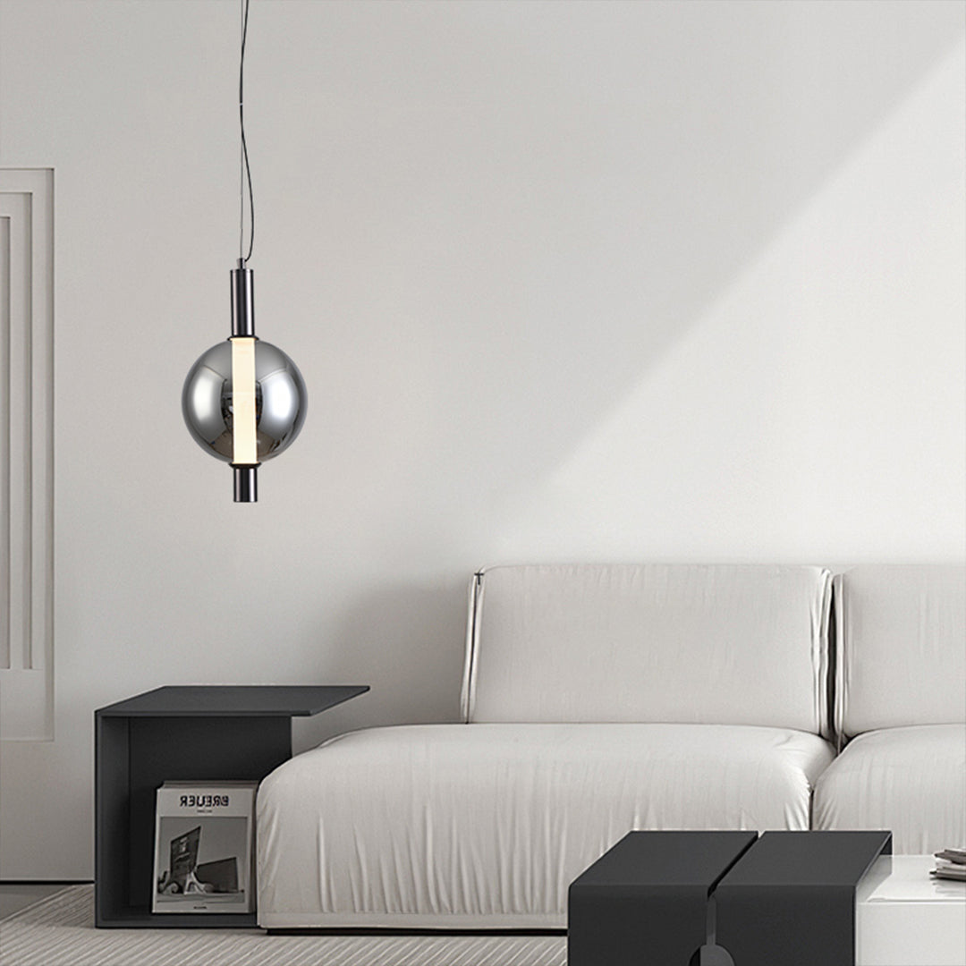 Triple modern silver pendant light installation with matching transparent globe fixtures over dining table