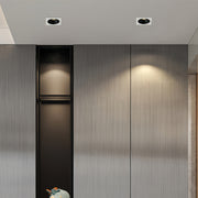 Triple square recessed downlight with black interior and white frame on a gray surface