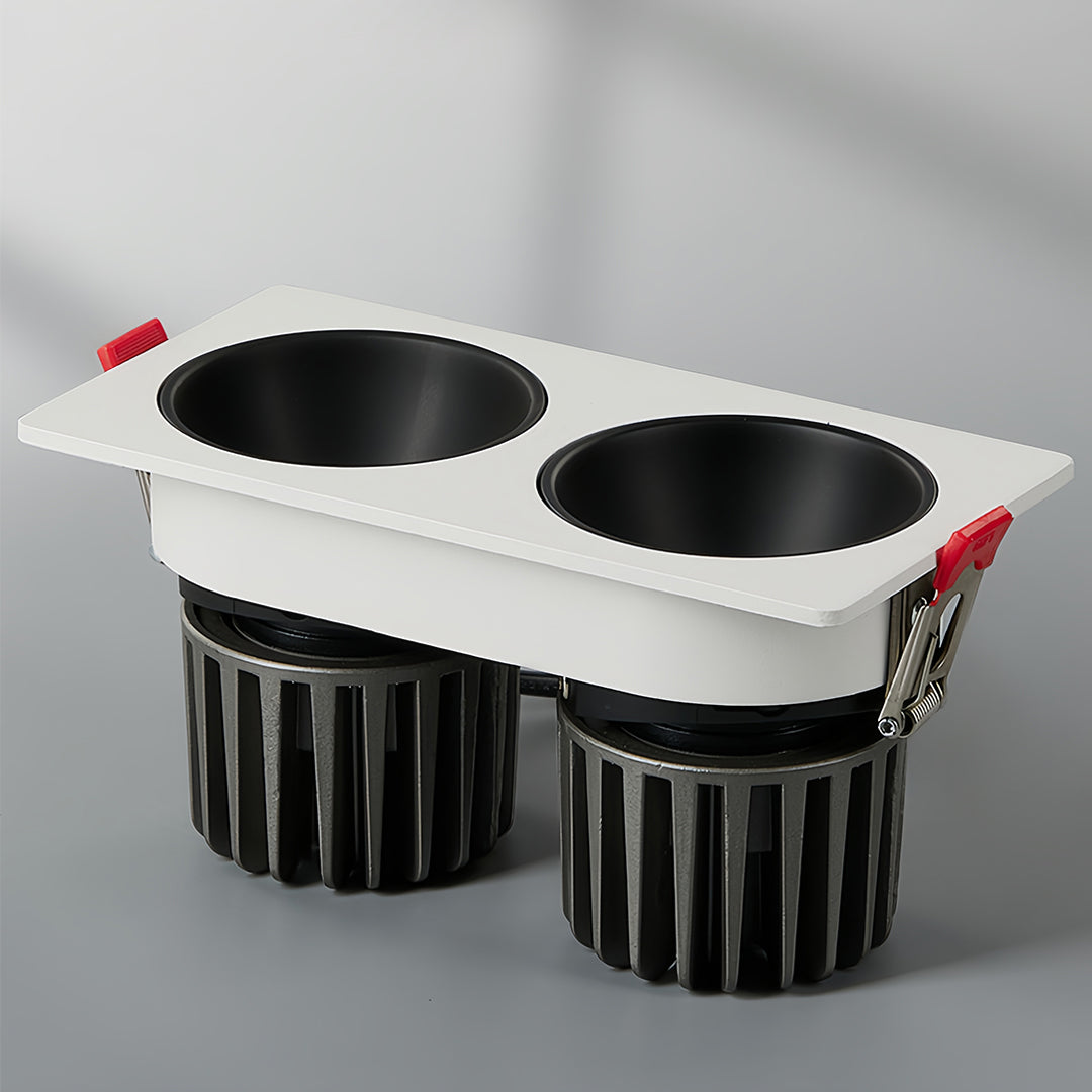 Triple square recessed downlight with black interior and white trim in a modern setting