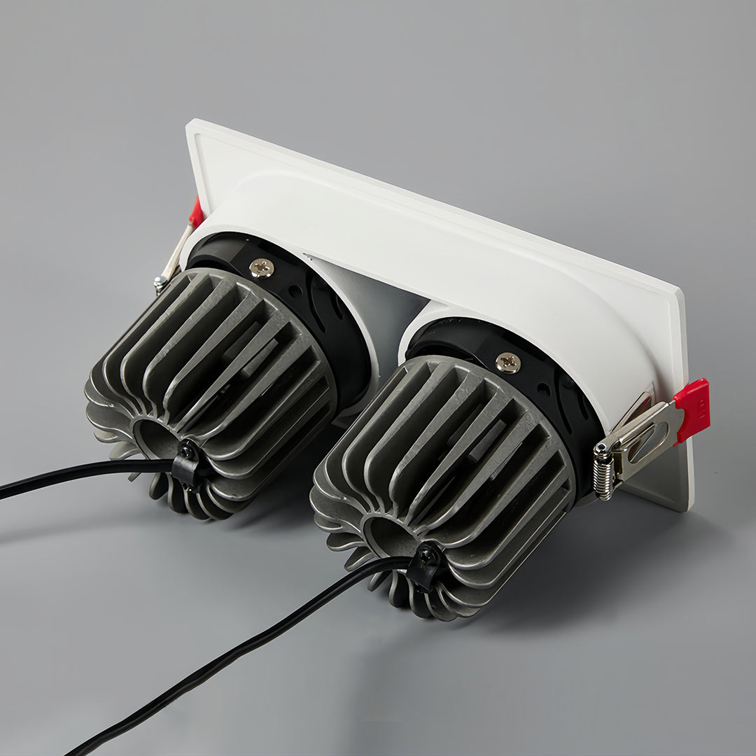 Triple square recessed downlight with black interior and white housing, showcasing warm light