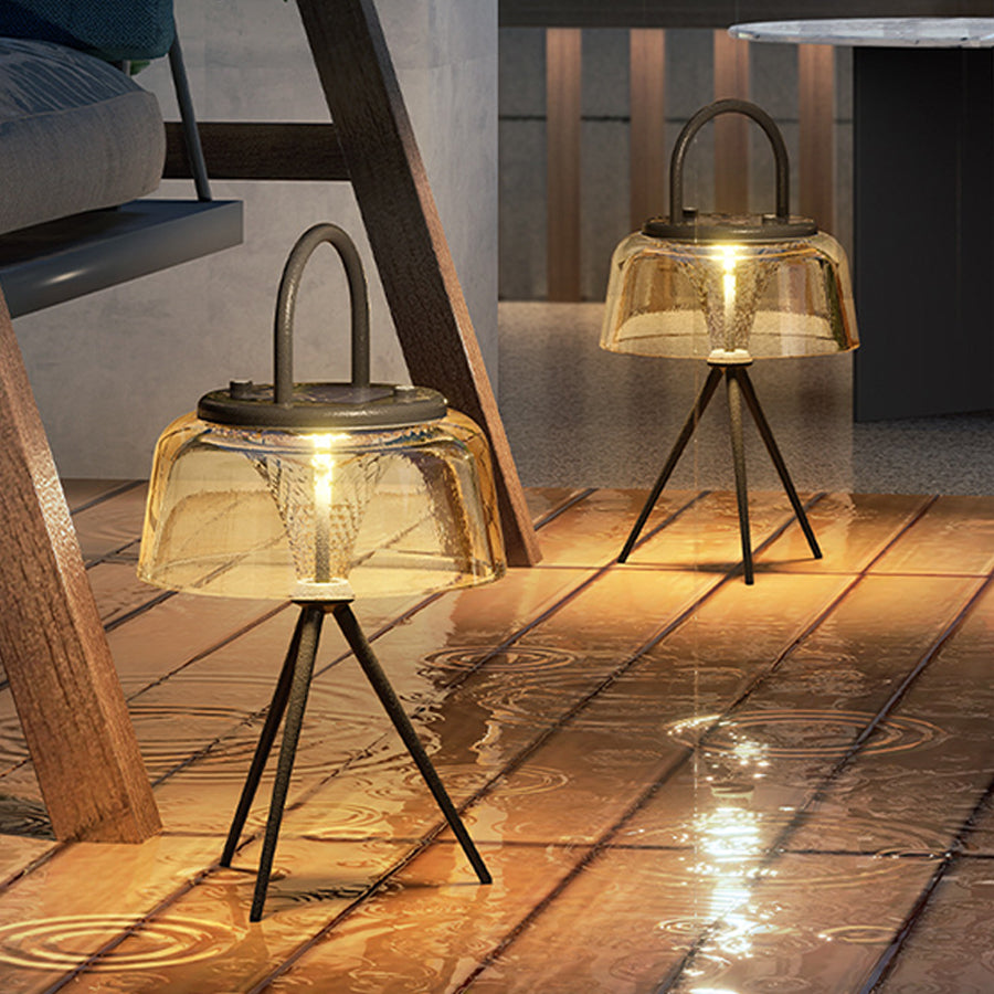 Set of modern glass table lamps with tripod wooden bases creating cozy ambient lighting