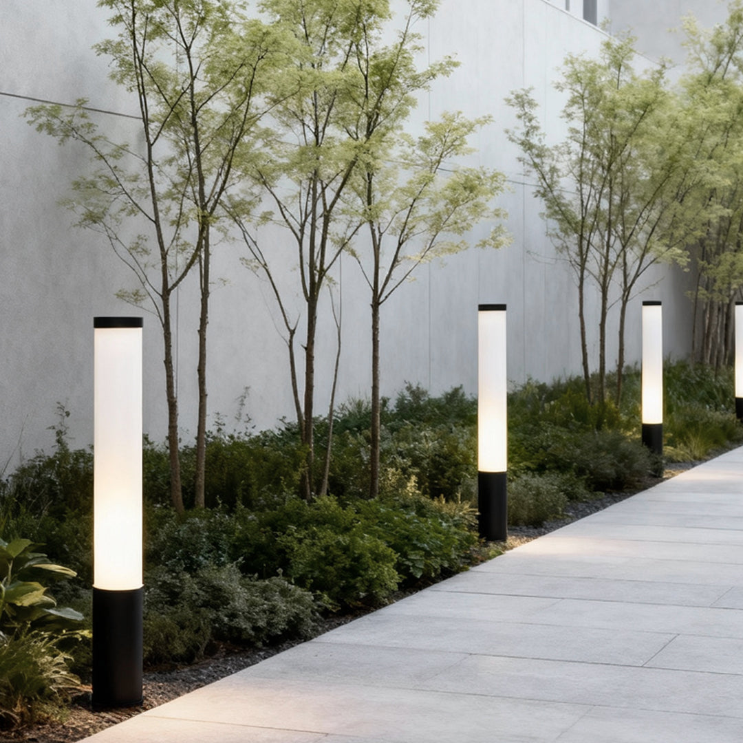 Tube landscape light illuminating a garden pathway, providing modern and minimalist outdoor lighting.