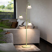 Tulip floor light illuminating a modern living room with a gray sofa and wooden coffee table.