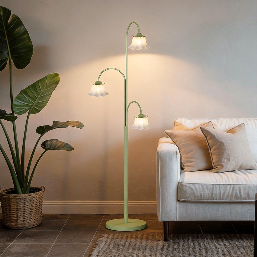 Tulip floor light adding a warm glow to a cozy living room with a beige armchair.