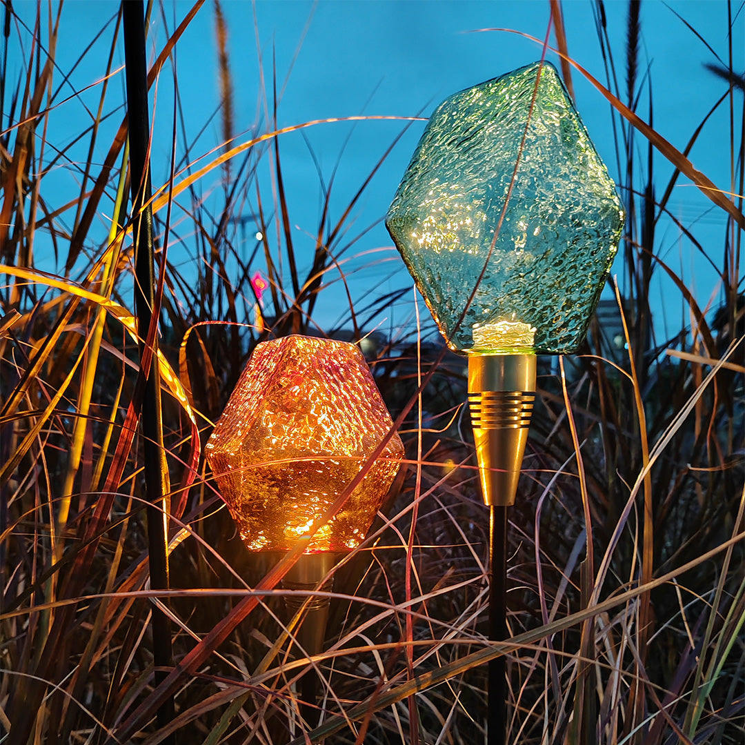 Amber globe stake shining vividly in twilight, crafted for aesthetic landscape lighting pathway ambiance.