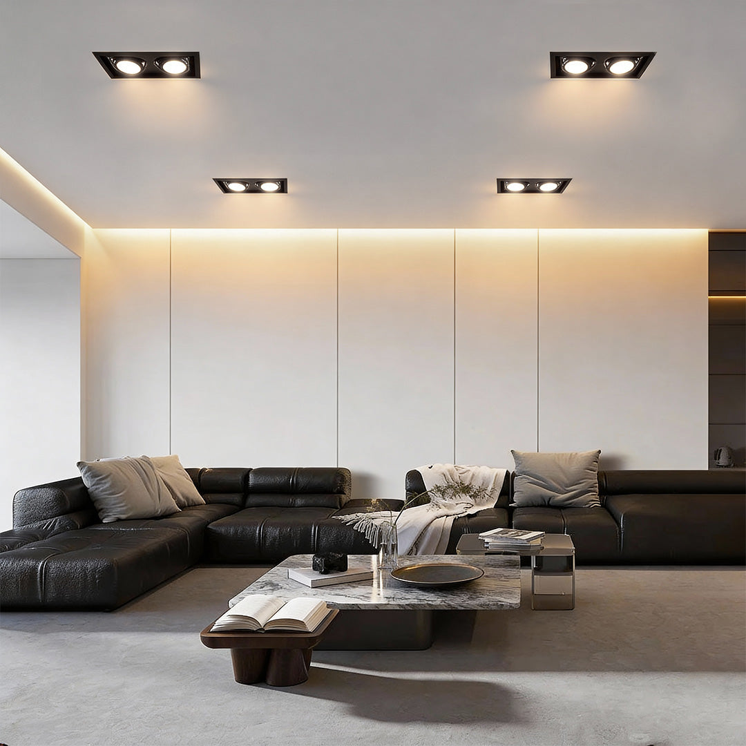 Twin recessed ceiling lights illuminating contemporary living room with soft ambient lighting.