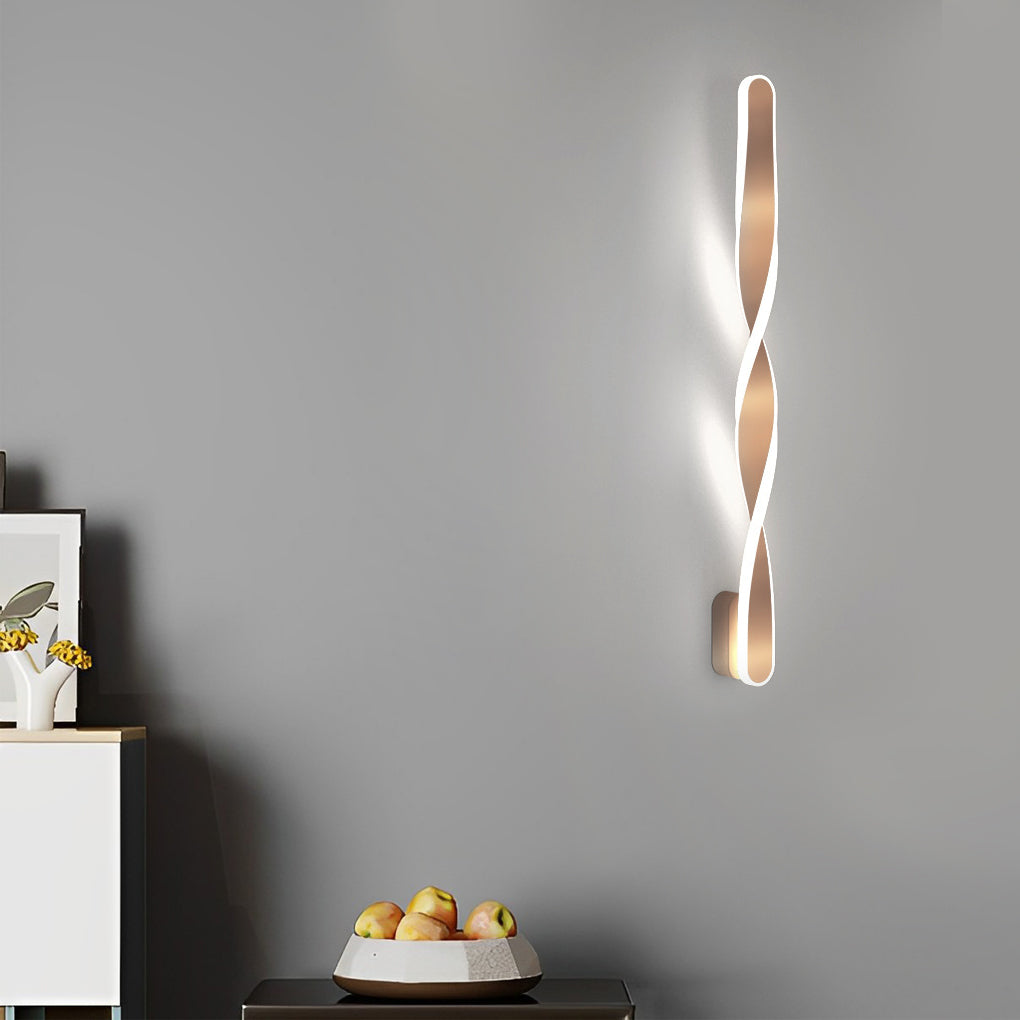 Twisted LED wall lights with a sleek design, installed in a minimalist dining room.