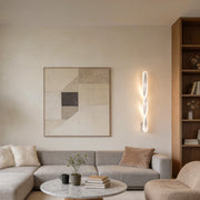 Twisted LED wall lights with a sleek white design, installed in a modern living room.