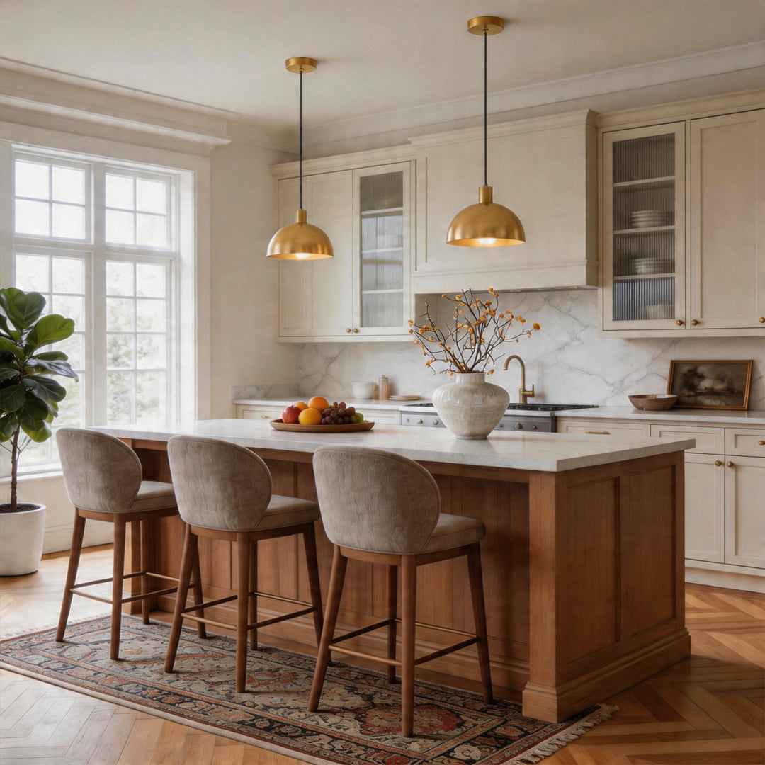 Two brass pendant lighting fixtures illuminating a wood kitchen island with beige bar stools ok